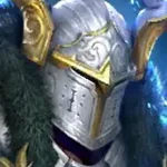 Close-up of a silver fantasy knight helmet with gold trim and engraved details.